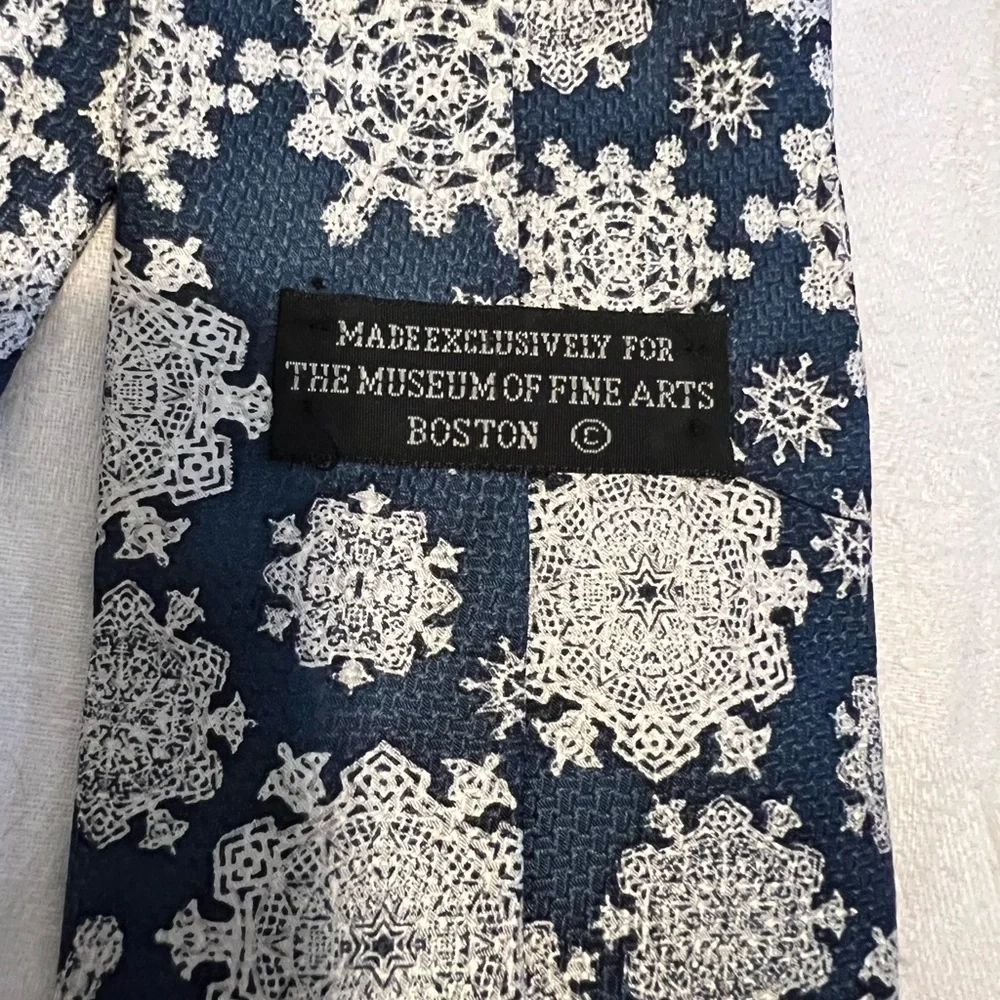The Museum of Fine Arts, Boston tie in snowflakes. Teal and white.